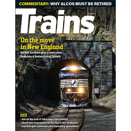 Magazine cover featuring a train emerging from a tunnel with text about trains in New England.