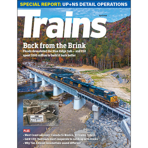 Magazine cover featuring a train on a bridge with a scenic background
